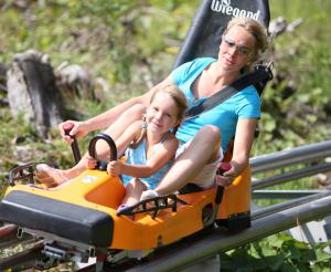 Mother and daughter in the typical orange sledge
