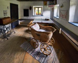 Old parlour with pram in the Salzburg Open-Air Museum