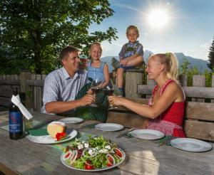 Familie bei einer Jause auf der Breitenebenalm