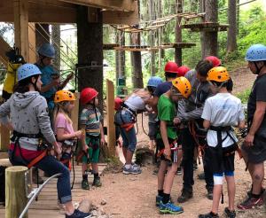 A group of visitors at the start of the high ropes course